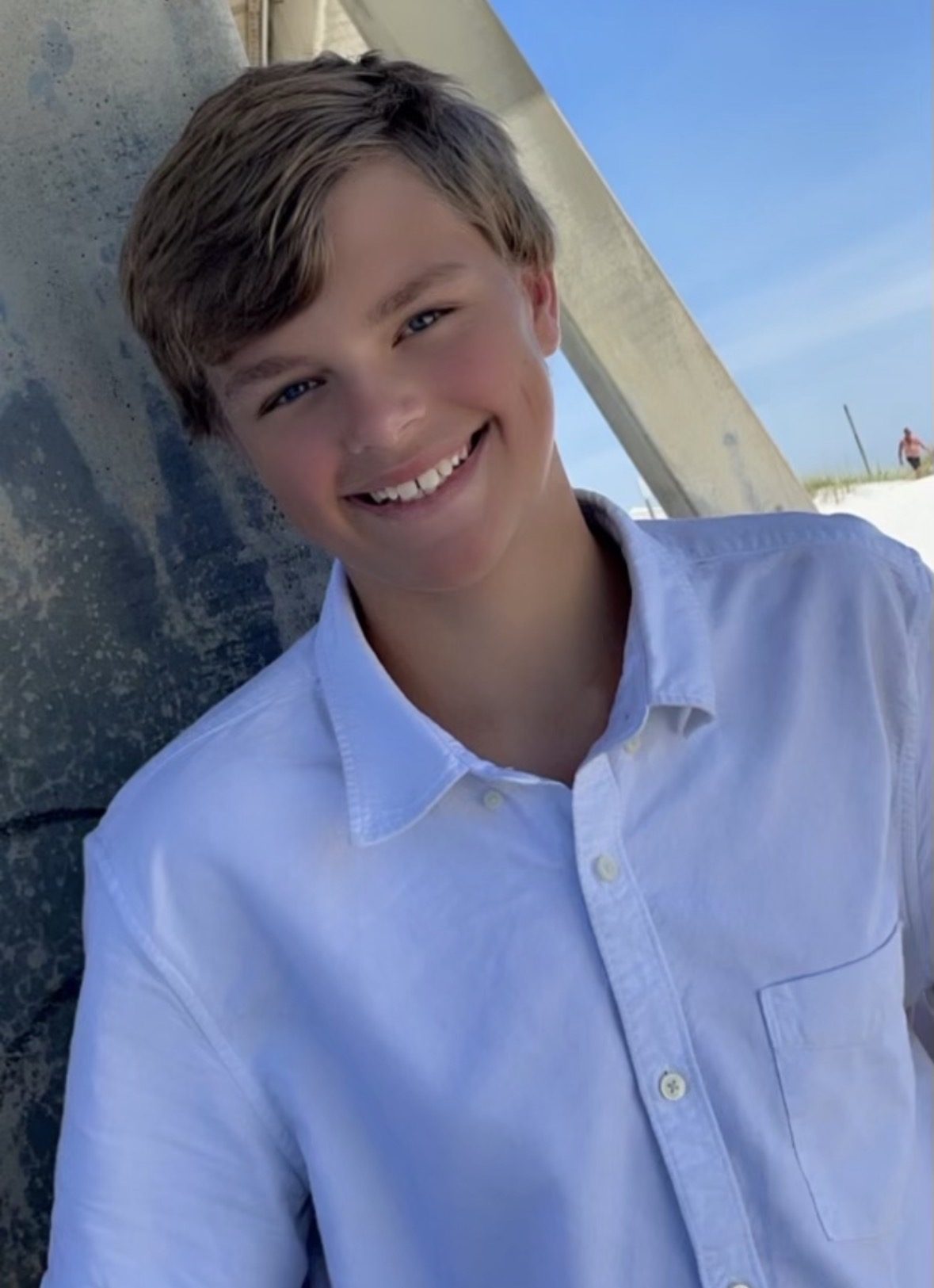 Connor Taylor smiling on the beach