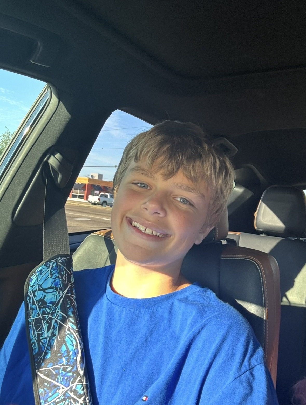 Connor Taylor grinning in the car