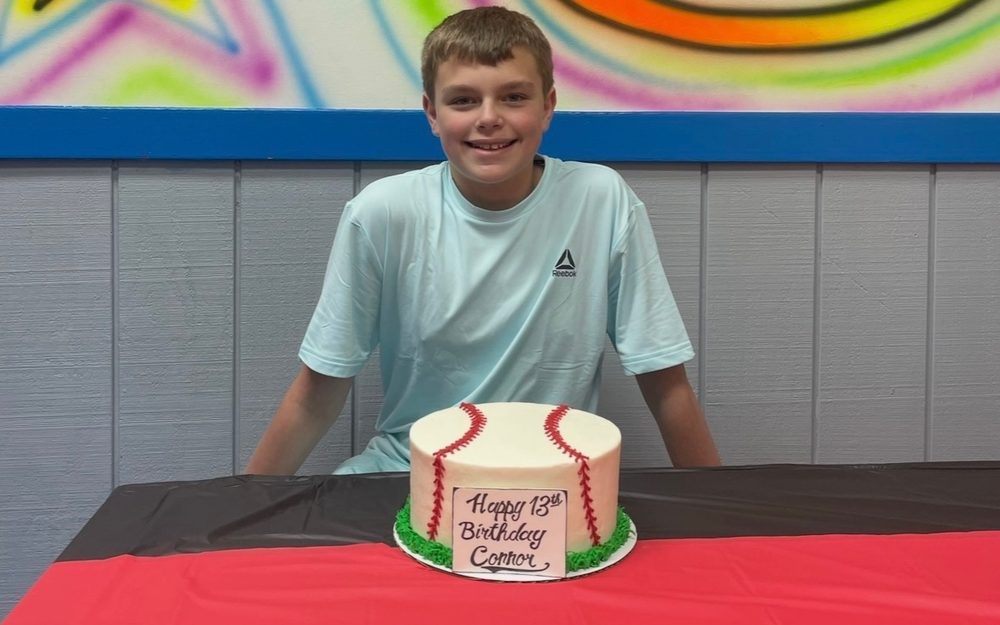 Connor at his 13th birthday with a baseball cake